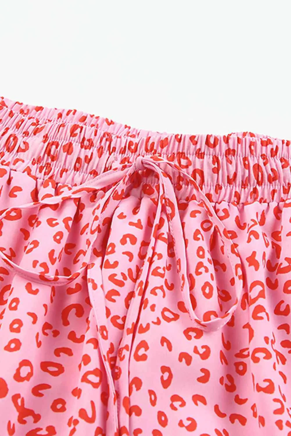 Pink leopard print tiered skirt with an elastic waistband and drawstring tie.