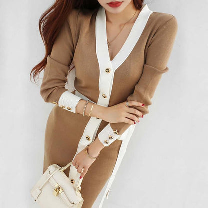 Woman wearing a tan knitted dress with white trim and gold button details by Lunara