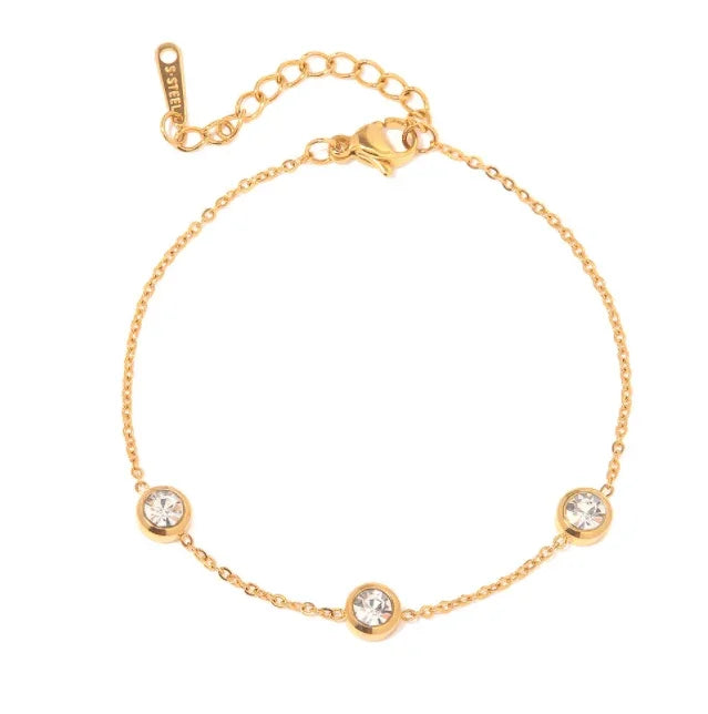 Elegant gold zircon bracelet with three sparkling round stones on a delicate chain.
