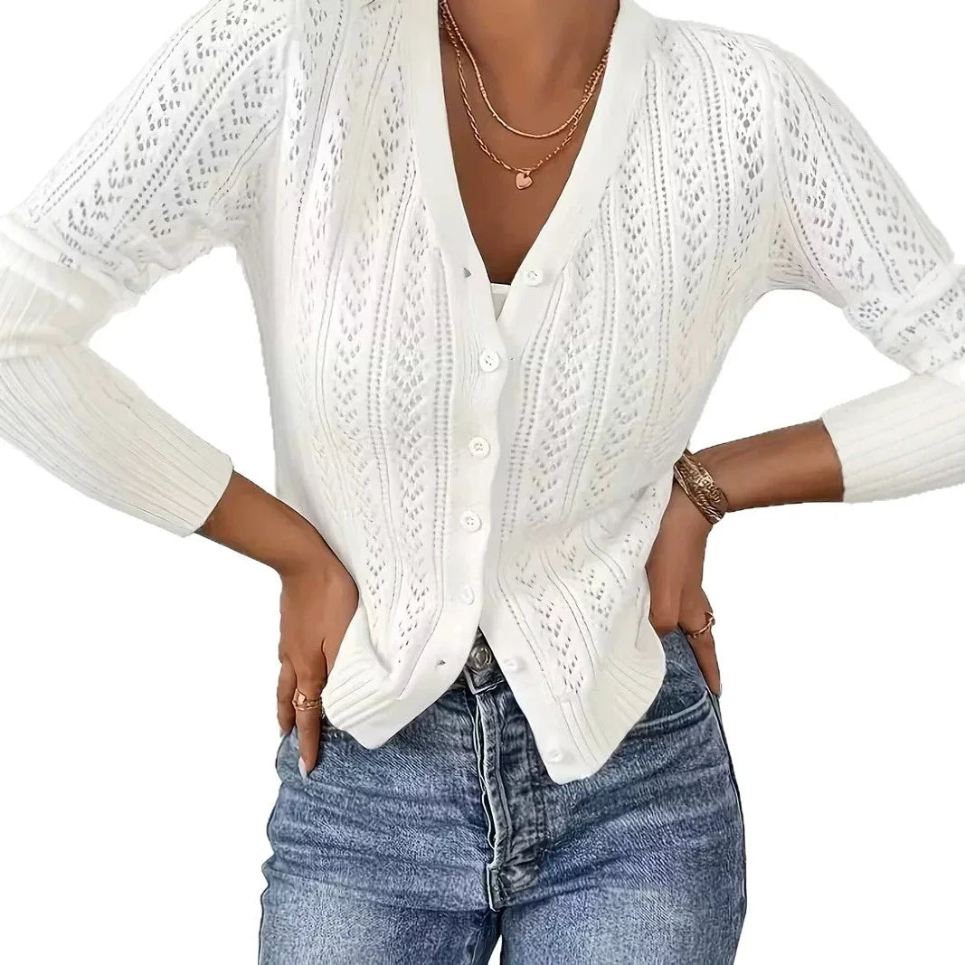 Woman wearing a white long-sleeve knit cardigan sweater by Fashion Images V2 and blue jeans.