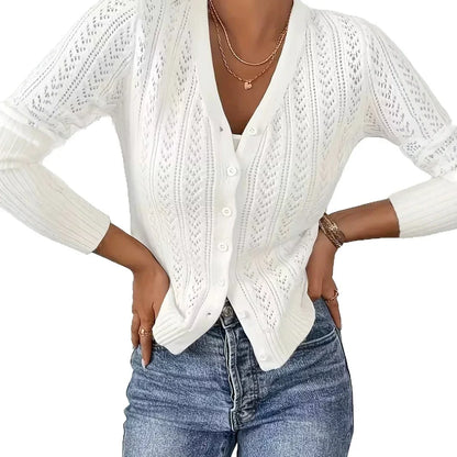 Woman wearing a white long-sleeve knit cardigan sweater by Fashion Images V2 and blue jeans.