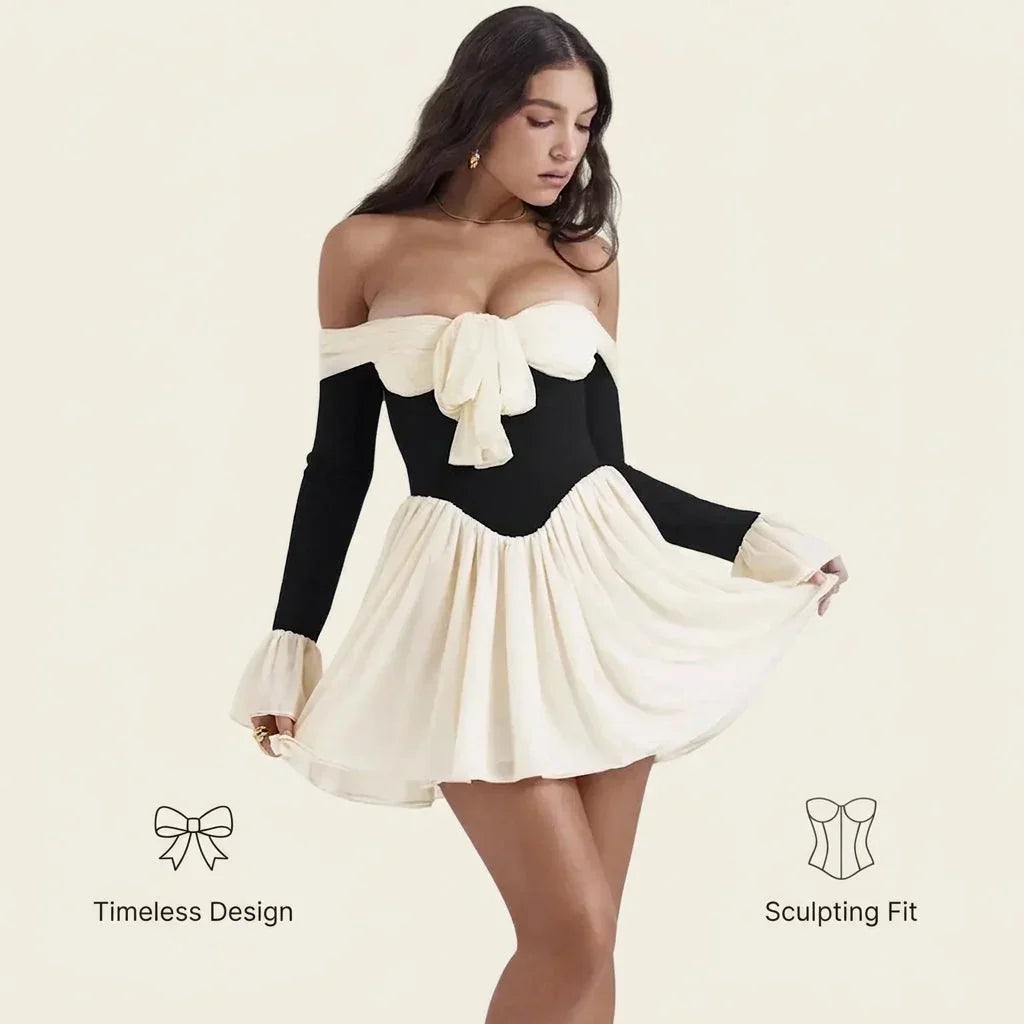 Model wearing Dalia Noir Dress by Fashion Images V2 in a black and cream sculpting fit.